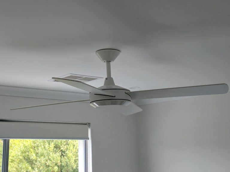 white ceiling fan in bedroom with downlights
