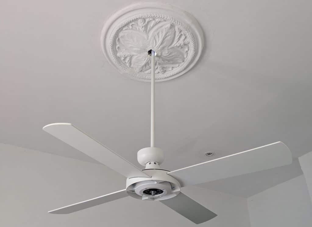 white ceiling fan on extension rod through ceiling rose