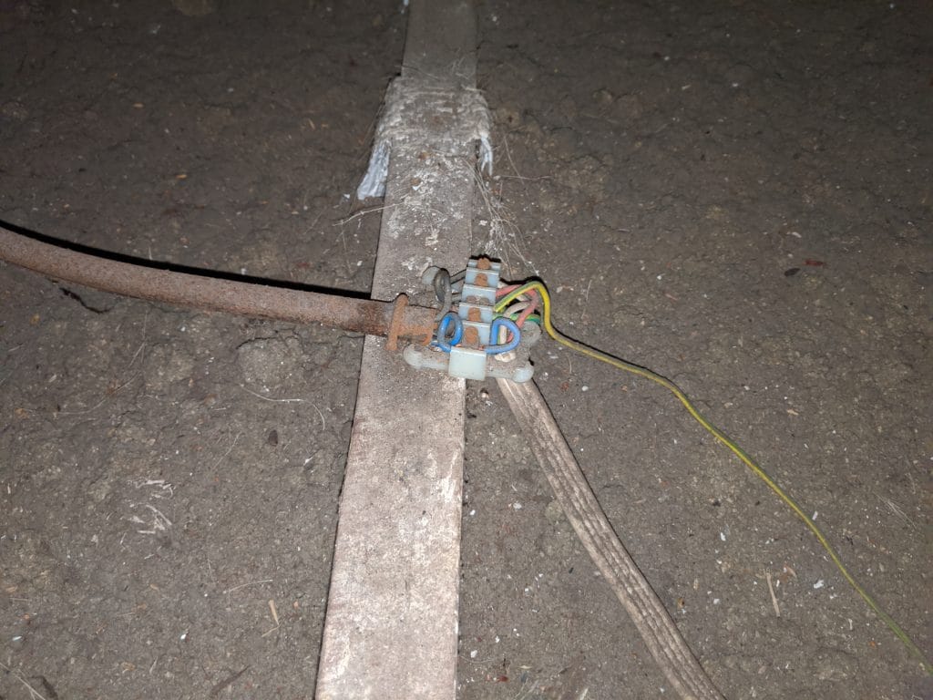 Exposed contacts of a junction box within a roof space